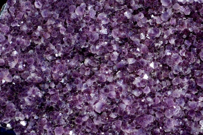 Close view of pale and deep purple amethyst crystals