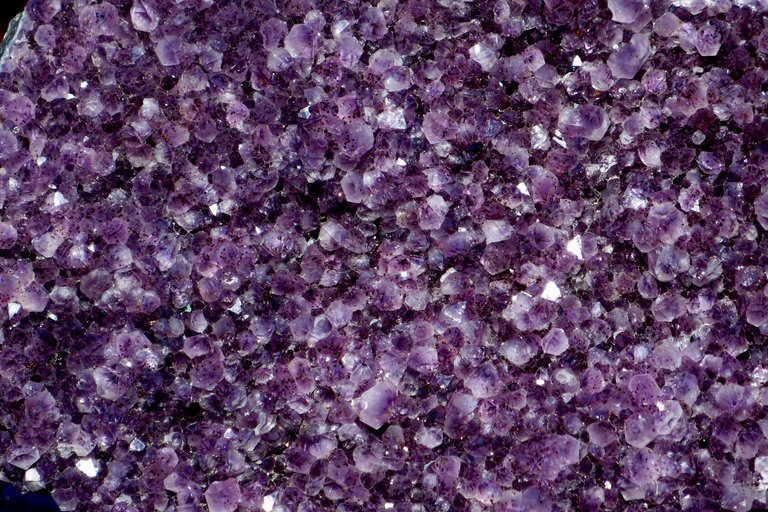 Close view of violet amethyst crystal points.