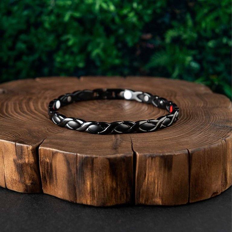 The Brainwave Activation Bracelet on a round wood slab